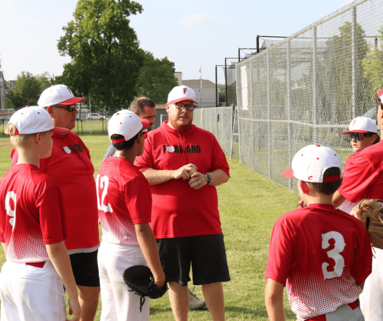 Coach Justin Johnson Forward Athletics Club on a Baseball Field with the Boys Baseball Team.