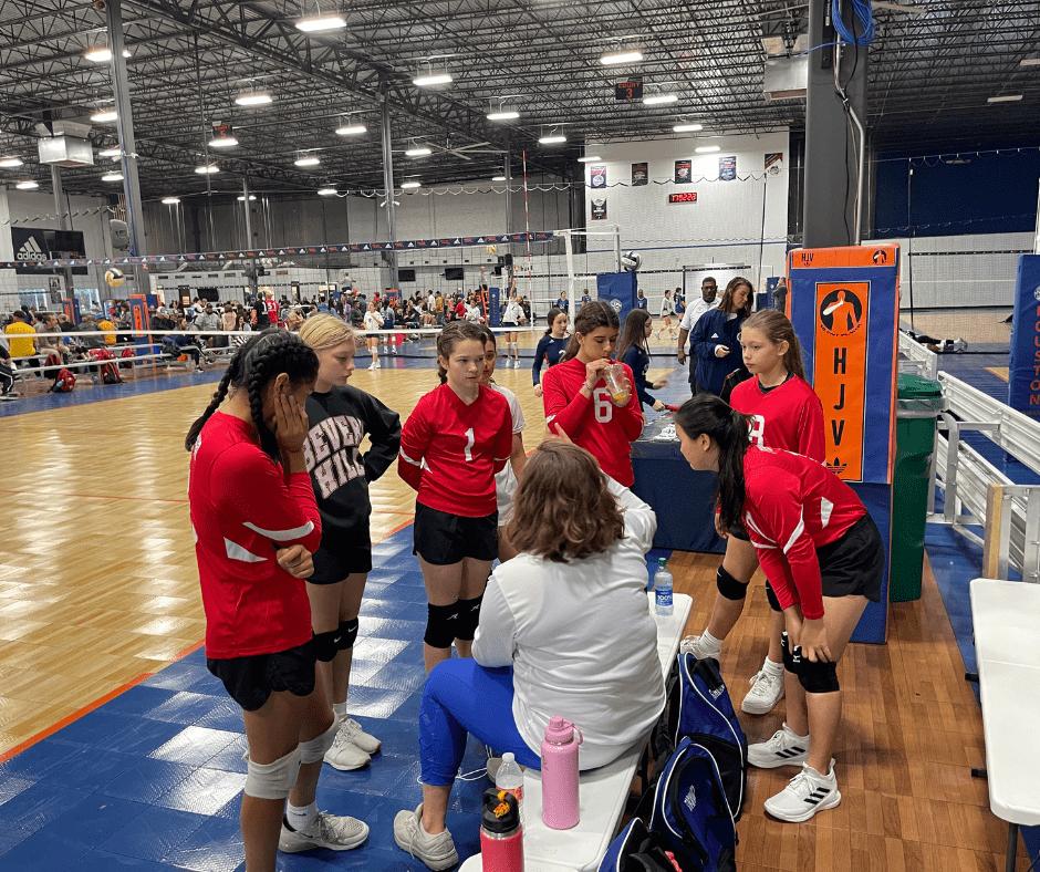 Forward Athletics Club Girls Volleyball Team Getting a Pep Talk from Coach Blair Johnson during a Volleyball Game.