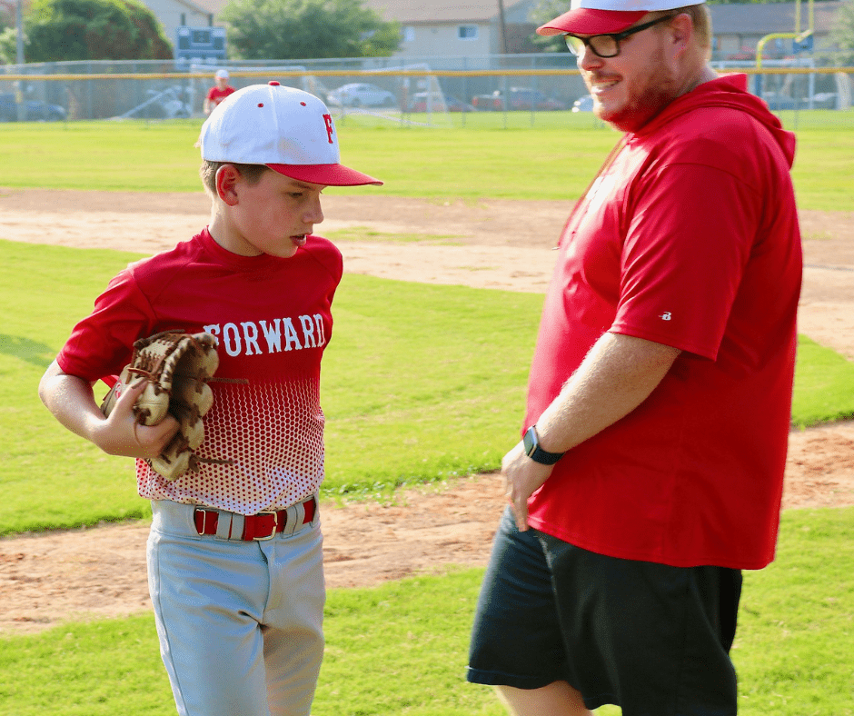 Forward Athletics Club Boys Baseball Team. Coach Justin Johnson talking to a Player During a Baseball Game.